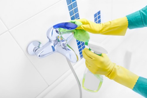 Carpet cleaner wearing PPE while working in an East Finchley property